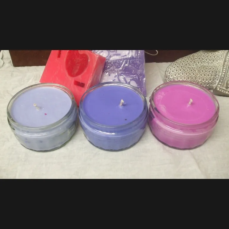 Original photo: three handmade candles in glass jars on a cloth, with packaging behind