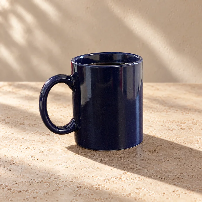 AI output: the dark blue mug on stone in warm directional light